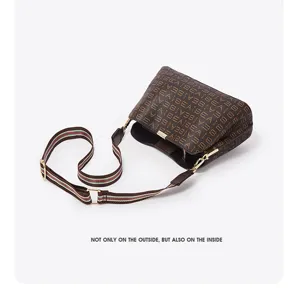 Stylish brown monogram bucket bag with web strap, perfect for daily commuting and women.