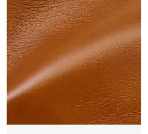 Detailed close-up shot of retro brown leather material showcasing fine natural texture and grain.