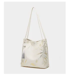Close-up detail view of the elegant New Chinese style women shoulder tote bag with chic leaf pattern.
