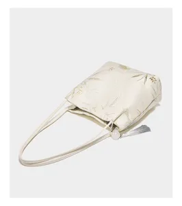 Detailed view of a chic Chinese style botanical print tote bag with elegant grey tassel accent.