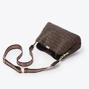 Chic brown bucket crossbody bag for women, featuring a striped web strap and gold tone hardware.