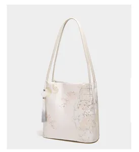 Elegant Chinese style women tote bag detail, featuring floral print and delicate tassel charm.