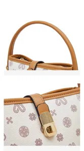 Detail close-up shot of women luxury bucket handbag, vintage clover print and gold lock.