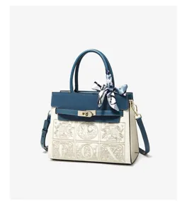 Blue and white colorblock handbag with metal lock, top handle and chic printed silk scarf accessory.