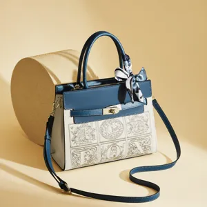 Elegant blue leather top handle shoulder bag with chic scarf and embroidered panel detail.