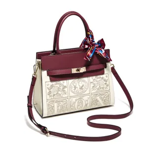 Burgundy and cream structured handbag with elegant embroidery, top handle and chic shoulder strap.