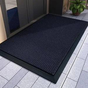 Textured mesh surface and durable black border detail of the heavy-duty entrance floor mat.