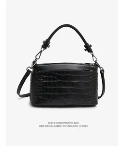 Detailed view of genuine leather women shoulder bag, crocodile pattern and pebble texture, chic.