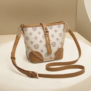 Stylish monogram bucket bag with gold chain and brown leather strap for women daily fashion use.