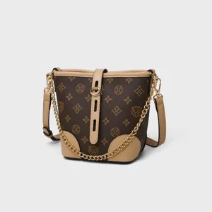 Stylish brown monogram bucket bag with beige leather trim and gold chain strap for women main
