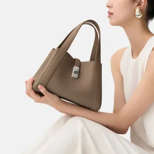 Elegant brown leather tote handbag for women, featuring a secure metal lock and durable handles.
