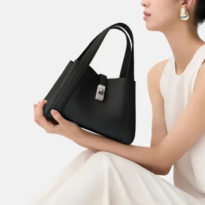 Black leather shoulder handbag for women with top handles and stylish metal lock closure design.