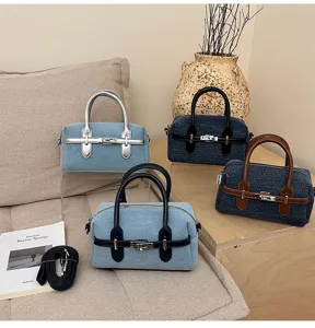 Casual denim bowling handbag for women with top handles and detachable shoulder strap.