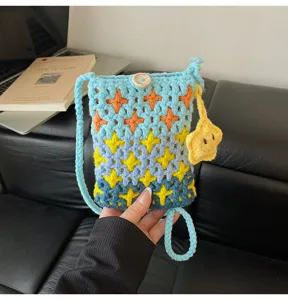 Detailed view of the cute knitted crossbody phone bag with colorful star patterns.