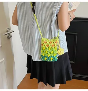Detailed view of the colorful knitted phone bag with cute star pattern and crossbody strap.