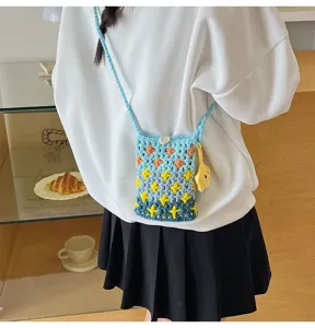 Handmade crochet crossbody phone bag with gradient blue color and cute star pattern details.