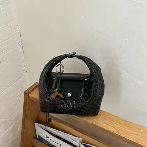 Black woven dumpling bag understated luxury shoulder handbag chic daily commuter purse