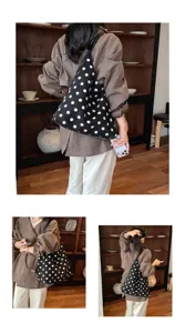 Detail view of casual polka dot suede shoulder bag showing large capacity and daily style.
