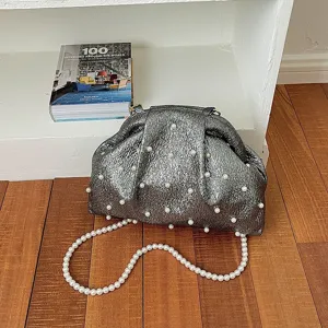 Silver metallic pleated pearl shell bag detail, elegant evening crossbody accessory for women.