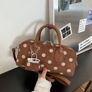 Brown suede polka dot handbag with top handles, shoulder strap and cute mini pouch charm.