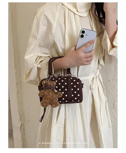 Stylish polka dot Boston handbag for women, retro brown shoulder crossbody bag with bear charm.