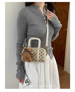 Chic polka dot Boston handbag with cute bear pendant, trendy shoulder crossbody bag for women.