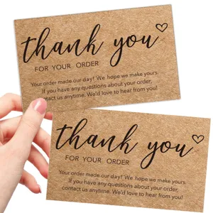 Detail view of kraft paper thank you cards with elegant black text for online orders.