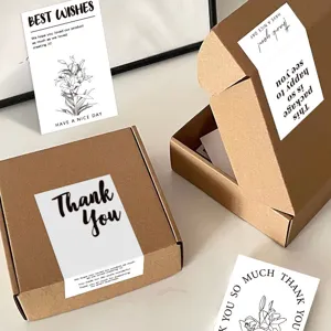 Kraft mailer boxes with minimalist thank you sealing stickers and greeting cards for packaging.