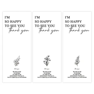 Detail view of minimalist rectangular thank you stickers with floral designs for gift packaging.