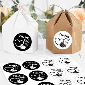 Round thank you stickers detail with gift boxes, perfect for baking and packaging decor.