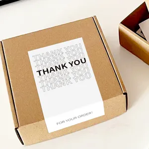 Minimalist thank you sealing sticker on craft paper mailer box for packaging decor.