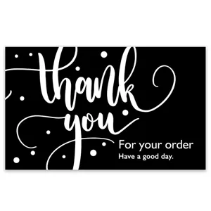Detailed view of black thank you card featuring elegant white calligraphy typography design.