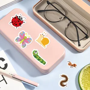 Close-up detail of cute cartoon insect stickers featuring ladybugs and butterflies for journals.