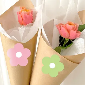 Closeup view of lovely colorful flower shaped sealing stickers on cute paper packaging details.