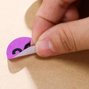 Colorful decorative sticker peel-off detail close-up view showing cute purple craft design.