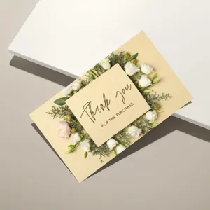 Detail view of a minimalist thank you card with floral wreath design and elegant font.