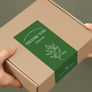 Green thank you sticker seal detail on brown gift box packaging for business and retail.