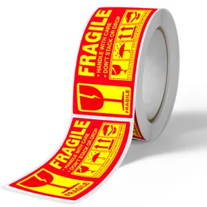 Fragile warning sticker roll detail, red and yellow self-adhesive delivery safety label.