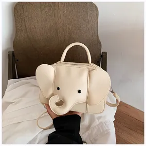 Cute cartoon elephant shaped handbag detail view, beige PU leather casual crossbody bag.