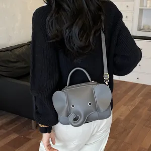 Detailed view of the cute elephant crossbody bag showing 3D ears and grey leather.