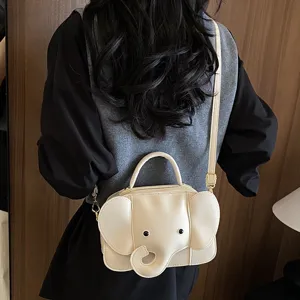 Cute elephant shape crossbody bag detail view showcasing unique cartoon design and leather strap.