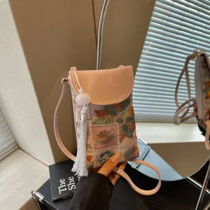 Chic pink embroidered mini phone crossbody bag with ethnic style patterns and elegant tassel.