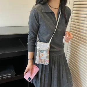 Traditional Chinese style embroidered mini phone bag with shoulder strap and chic white tassel.