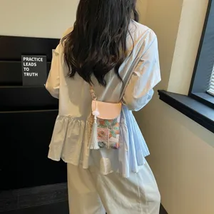 Chic Chinese style embroidered mini crossbody phone bag with elegant tassel detail and pink flap.