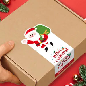 Detalle de pegatina navideña de sellado con tierno diseño de Papá Noel para caja de regalo.