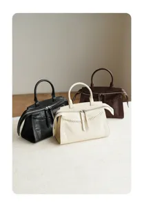 Detailed view of genuine leather retro handbags showing zipper closure and woven handle design.