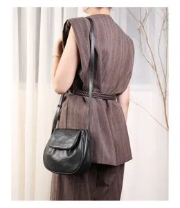 Detail view of a chic black leather saddle bag, perfect crossbody purse for women everyday use.