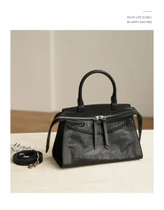 Vintage black genuine leather handbag with woven details, elegant top handle and shoulder strap.