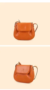 Detailed view of the stylish orange leather saddle bag showcasing fine texture and stitching.