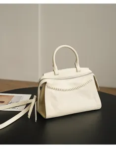 Cream leather handbag with top handle and strap, retro design for women's daily commute.